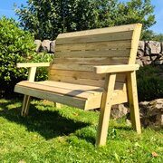 2 seater Clover Bench in the sun - full image of bench in a garden environment