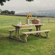 Churnet Valley Lunar Wooden Walk-In Picnic Table 150cm PT107 in a garden environment overseeing the nice views, set up for a picnic