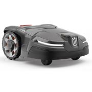 Angled front view of Husqvarna Automower 405X robotic lawnmower showing compact body, LED headlights, and all-terrain drive wheels