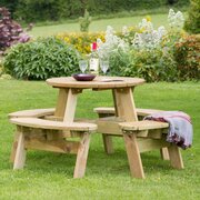 Katie Round Picnic Table full image in a garden