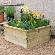 Sleeper Raised Veg Bed Square Raised Bed with plants inside of it