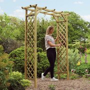 Woman standing next to Zest 4 leisure sunset arch admirirng the timber